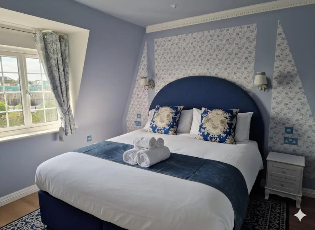 A bedroom with a bed and two stuffed animals at The Mad Hatter's Guestrooms in Oxford
