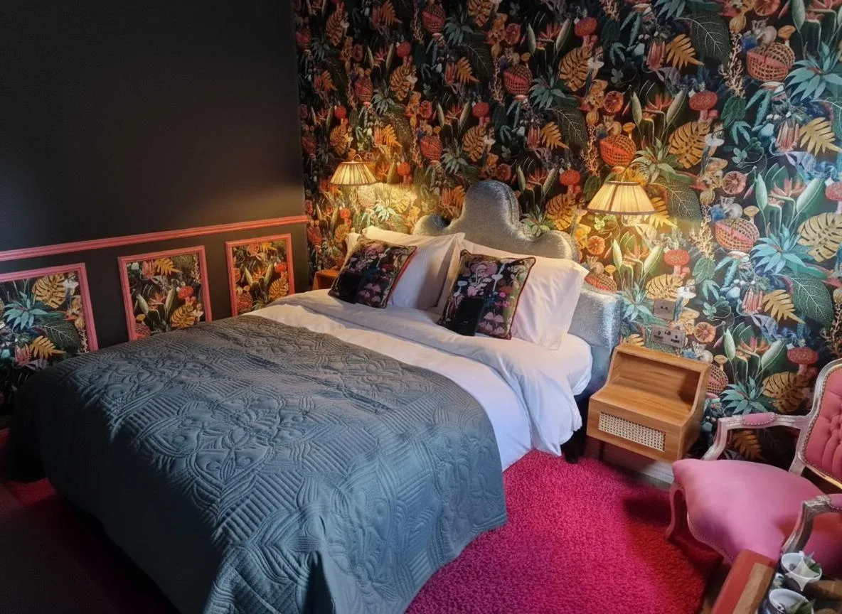 A bedroom with floral wallpaper at The Mad Hatter's Guestrooms in Oxford